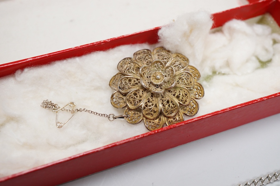 A collection of jewels, comprising: two amber pendants and an amber ring, each mounted in silver; a pair of gilt metal and enamel earrings of floral design; a pair of gilt metal earrings; a silver and cultured brooch; a